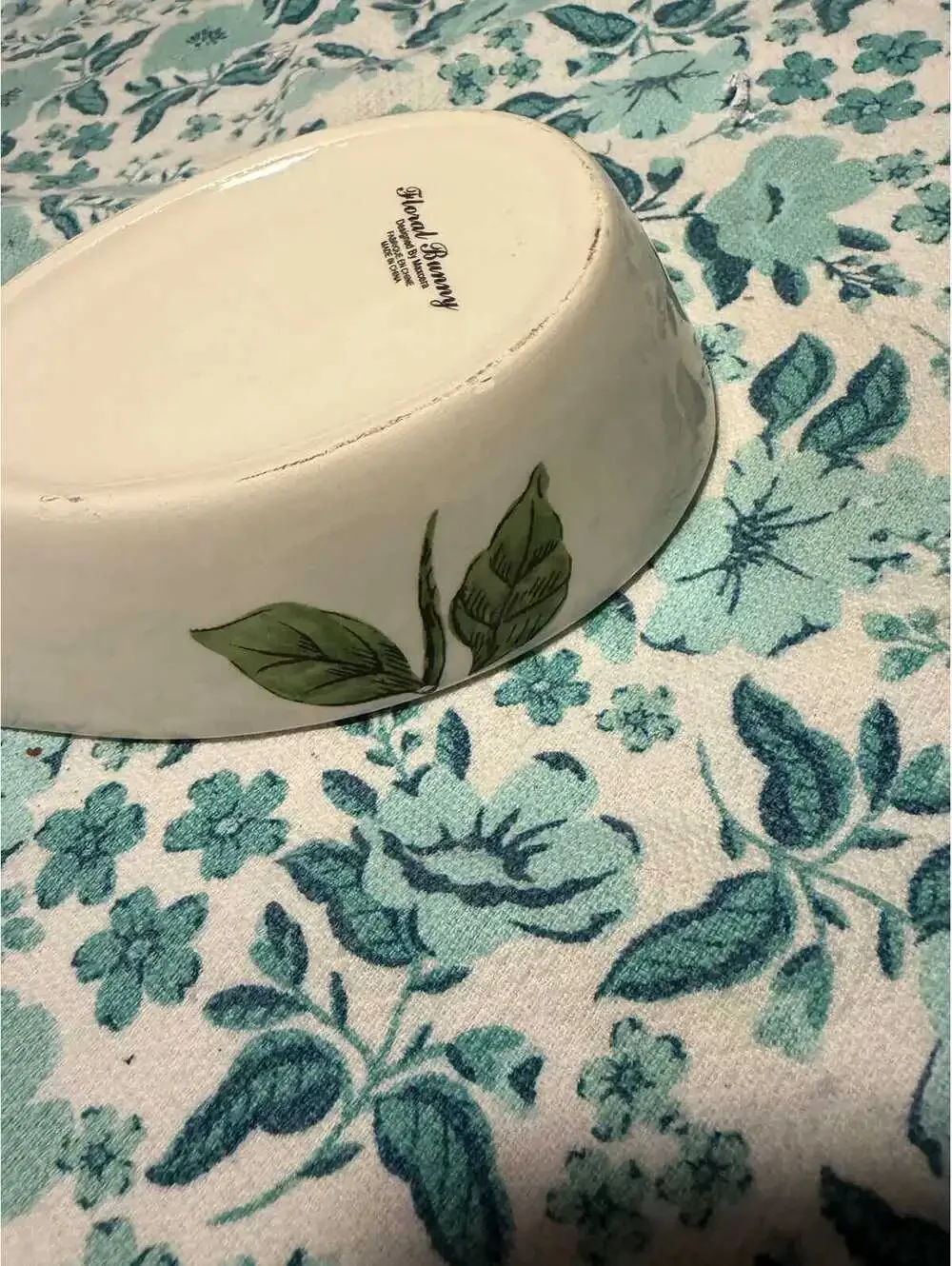 This is a Maxcera ceramic spoon rest featuring a rabbit and pink flowers.